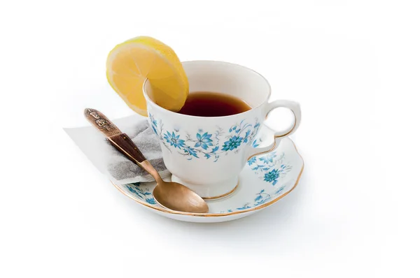 Tea cup with lemon on the side - china cup — Stock Photo, Image