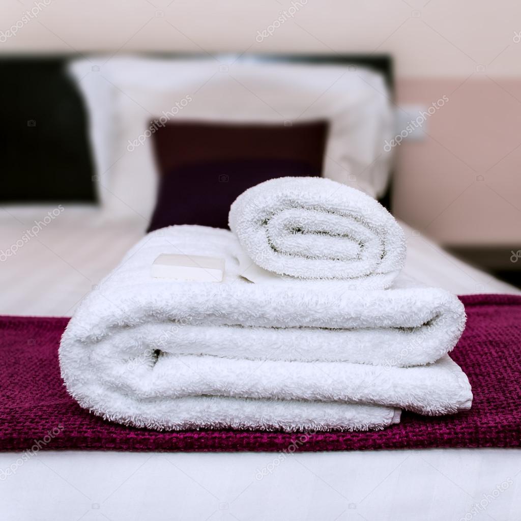 Closeup photo of clean towels and soap in a hotel room