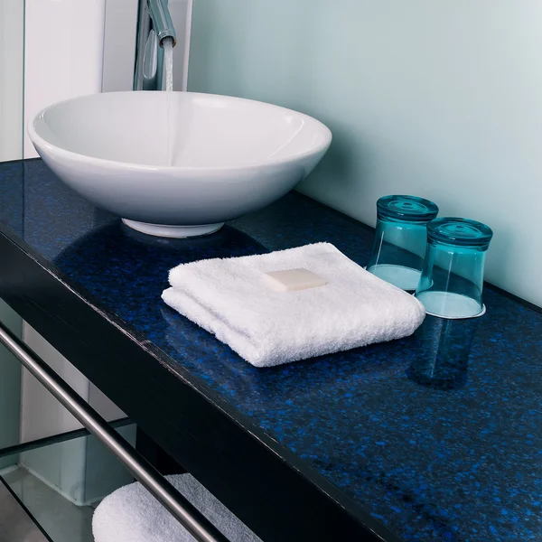 Bathroom sink counter towels water glass blue — Stock Photo, Image