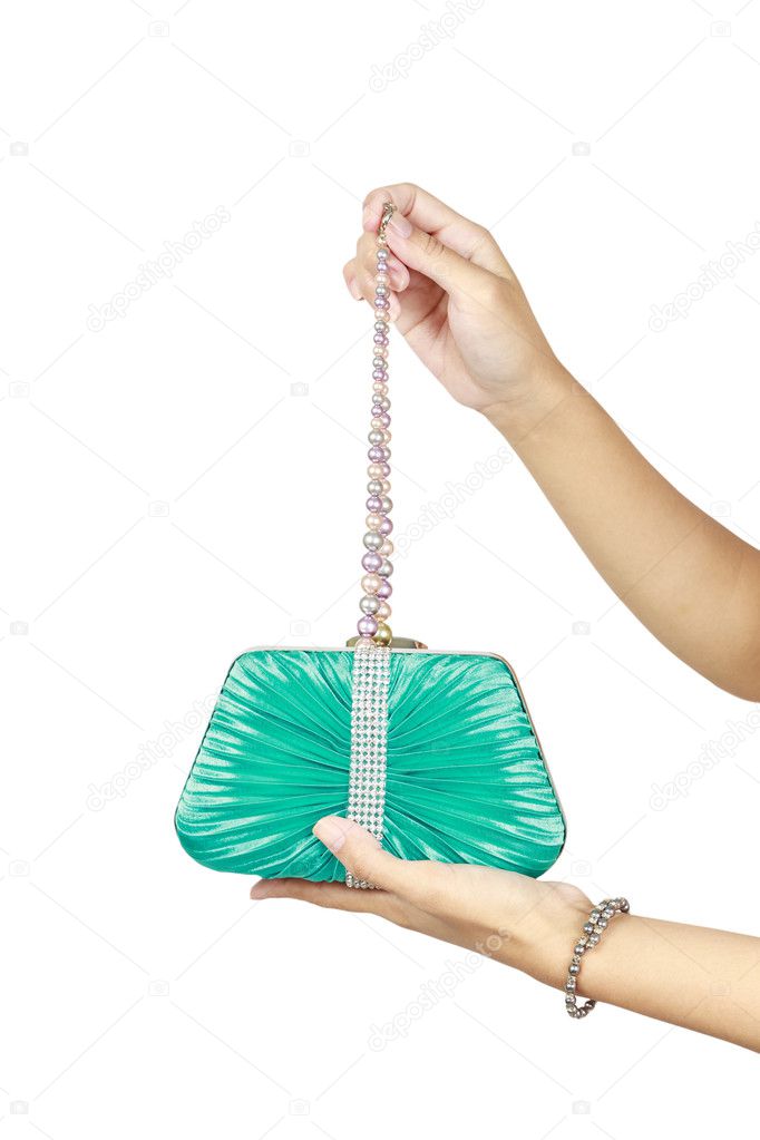 Woman's manicured hands holding fancy clutch with pearl beads inside