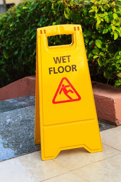 Sign with caution wet floor near the swimming pool — Stock Photo, Image