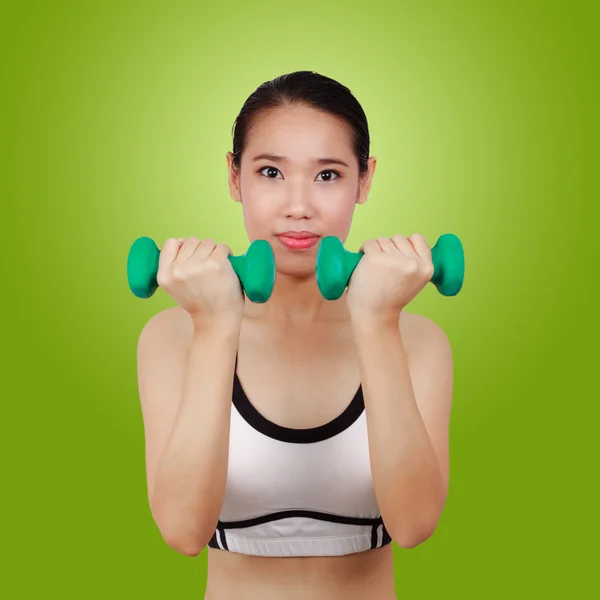 Portrait of Asian woman doing fitness with weights over a green — Stock Photo, Image