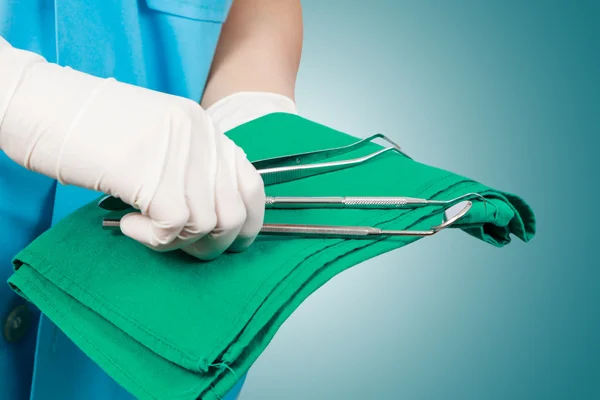 Closeup of dentist hand taking mirror from on of dental tools. — Stock Photo, Image