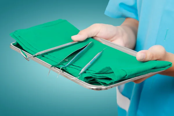 Closeup of dentist hand taking mirror from on of dental tools. — Stock Photo, Image