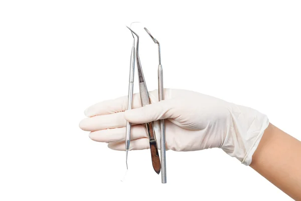 Hand in white glove holding dental tools isolated on white — Stock Photo, Image