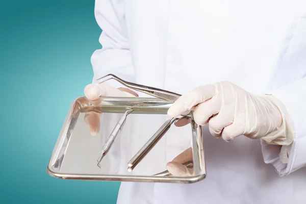 Closeup of dentist hand taking mirror from on of dental tools. — Stock Photo, Image