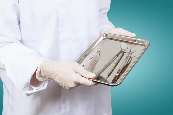 Closeup of dentist hand taking mirror from on of dental tools. — Stock Photo, Image