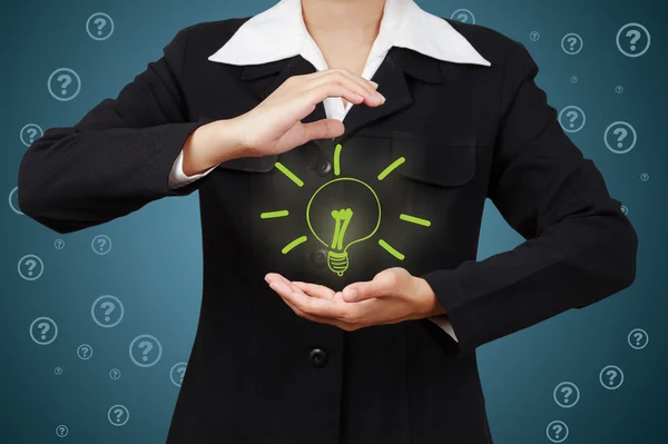 Hand with lamp and hands of a business person — Stock Photo, Image