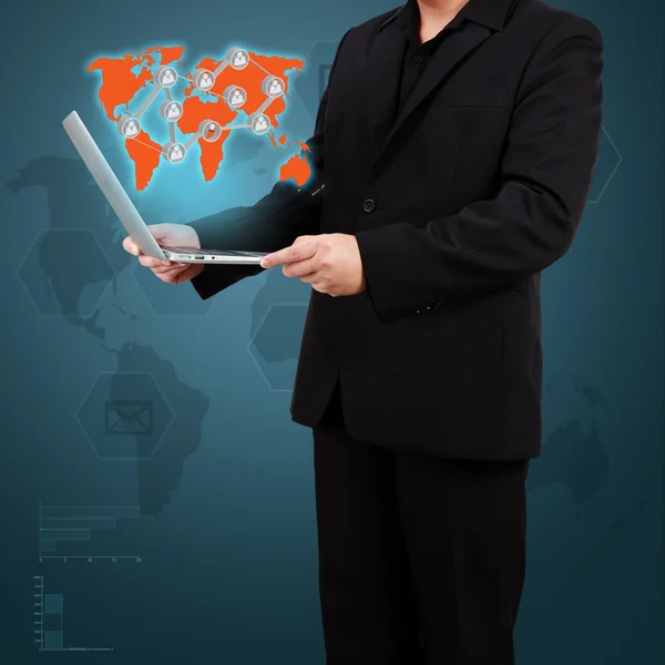 Businessman showing a world map and social icons on virtual scre — Stock Photo, Image