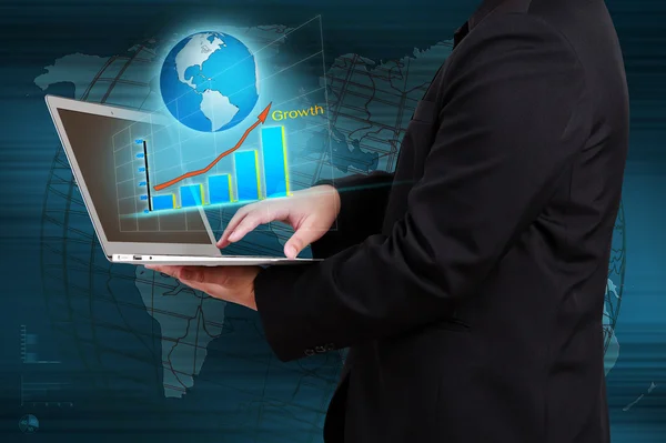 Businessman holding a laptop showing business graph and globe on — Stock Photo, Image