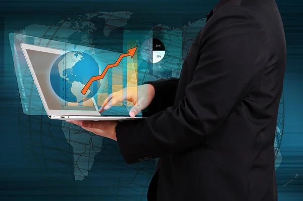 Businessman holding a laptop showing business graph on virtual s — Stock Photo, Image