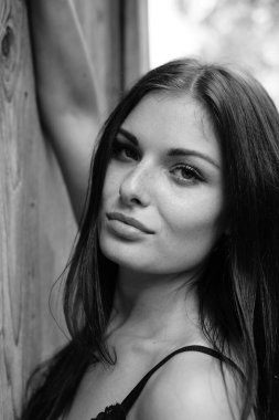 İç çamaşırı giymiş, açık havada poz veren güzel esmer kadın. 