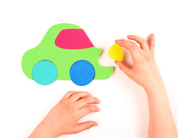 Hand and multicolored foam puzzle — Stock Photo, Image