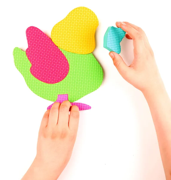 Hand and multicolored foam puzzle — Stock Photo, Image