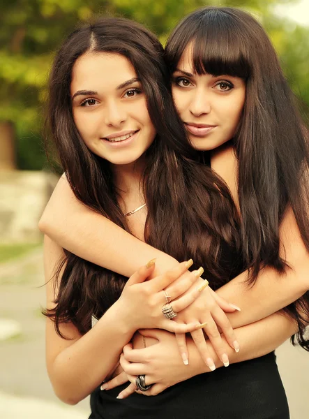 Portrait of young beautiful sisters outdoor — Stok Foto