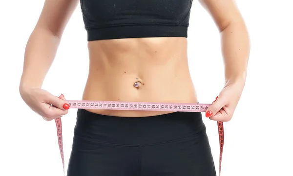 Young fitness woman measuring her waist — Stock Photo, Image