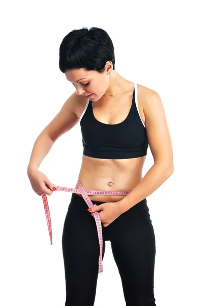 Young fitness woman measuring her waist — Stock Photo, Image