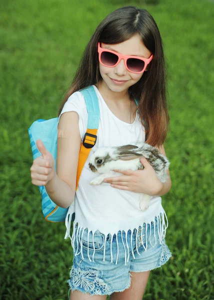 那女孩抱着一只可爱的小兔子 复活节兔子的象征 儿童与动物概念之间的友谊 — 图库照片