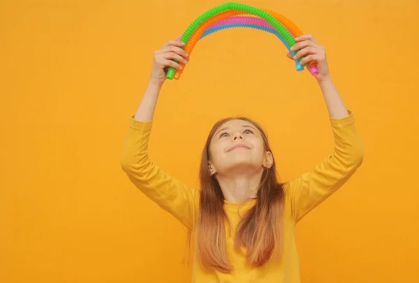 Smart Girl Yellow Clothes Plays Trendy Toy Pop Tube —  Fotos de Stock