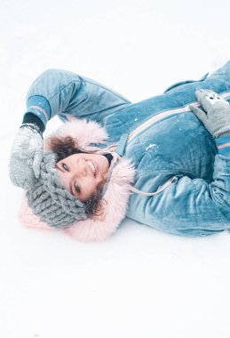 Güzel, gülümseyen bir kadın dışarıda eğleniyor. Karlı ormandaki kadın. Kış tatili.