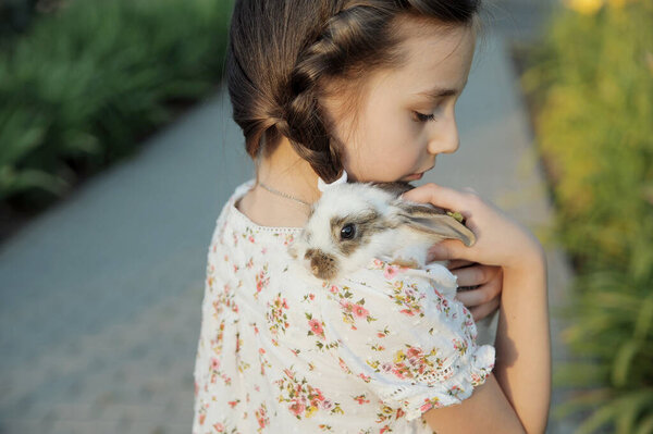 Girl Hugging Baby Rabbit Outdoors — Stock Photo, Image
