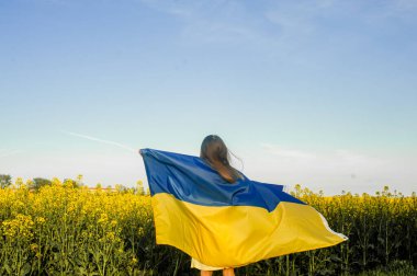 Çayırda Ukrayna bayrağı taşıyan çocuk