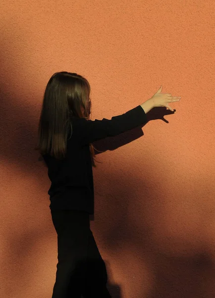 Cute Little Girl Playing Shadow Theater Orange Color Background — Stock fotografie