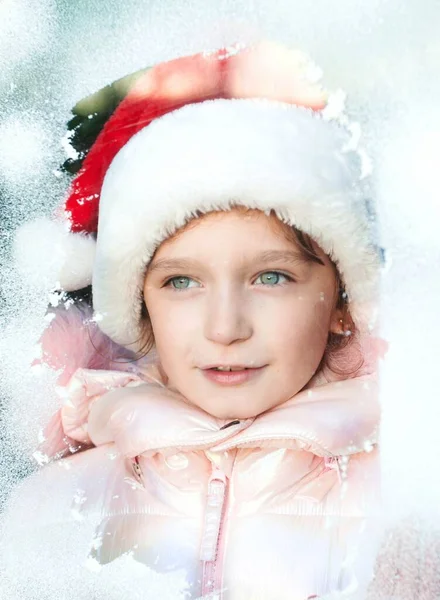 Girl Santa Claus Costume Looking Throught Snowy Window — Fotografia de Stock