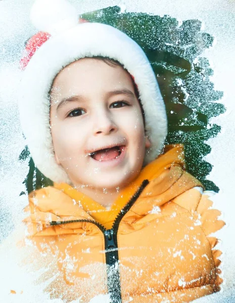 Little Boy Santa Claus Costume Looking Throught Snowy Window Stockbild