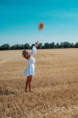 portrait of young woman posing outdoors in a beautiful dress