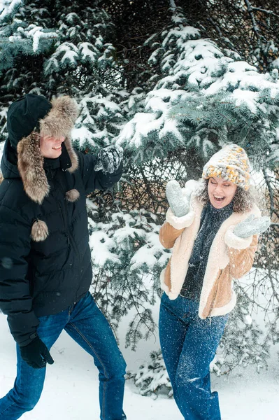 happy young family in love and playing on the snow in winter park