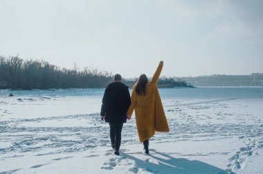 happy couple walking on ice