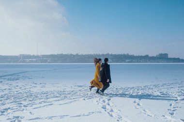 happy couple walking on ice