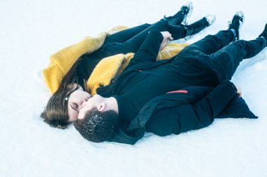 happy couple playing with snow on ice