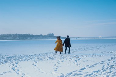 happy couple walking on ice