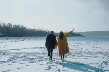 happy couple walking on ice