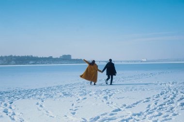 happy couple walking on ice