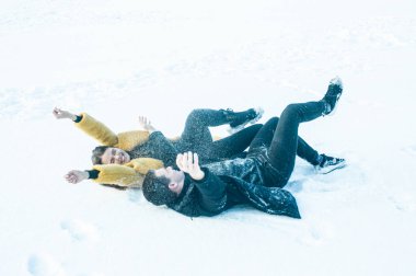 happy couple playing with snow on ice