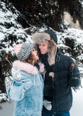  family playing on the snow in winter park