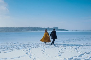 happy couple walking on ice
