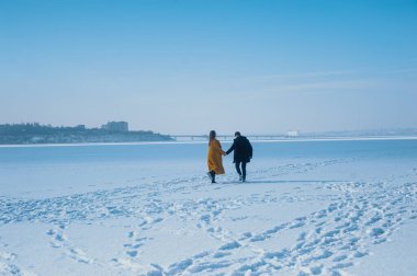 happy couple walking on ice