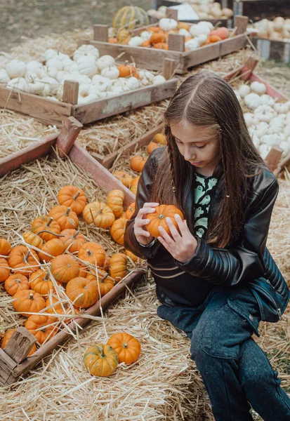 girl with a pumpkin on autumn market