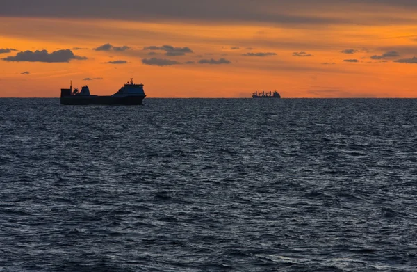 Two merchant ships underway at sunset — Stock Photo, Image