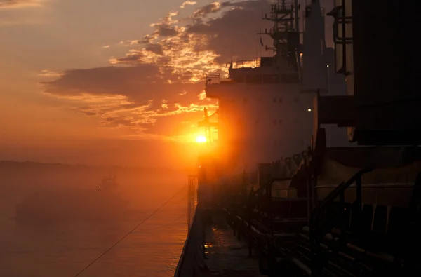 Cargo ship at sunset — Stock Photo, Image