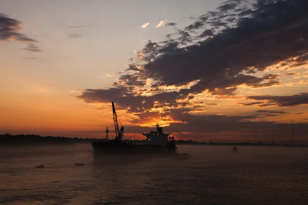 Cargo ship at sunset — Stock Photo, Image