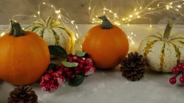 Thanksgiving Day. Pumpkin. The table is decorated with pumpkins and a garland. Festive scene of the autumn festival, autumn, dinner. 4K