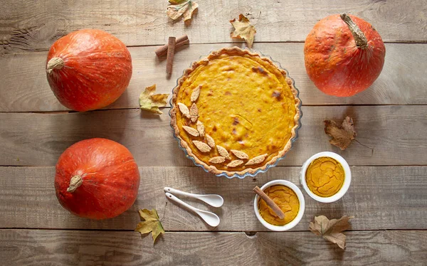 Thanksgiving background. Pumpkin pie on a wooden background. Pumpkins. View from above. Banner. copy space