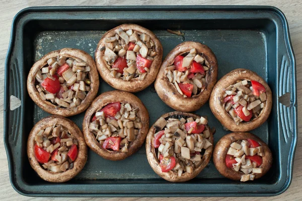 Stuffed mashrooms with tomato in the black form — Stock Photo, Image