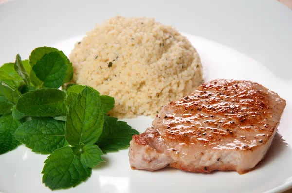 Vitela frita com cuscuz na placa branca — Fotografia de Stock