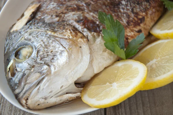 Fried (roasted) Fish (Dorado) Garnished with Lemon, Tomato — Stock Photo, Image